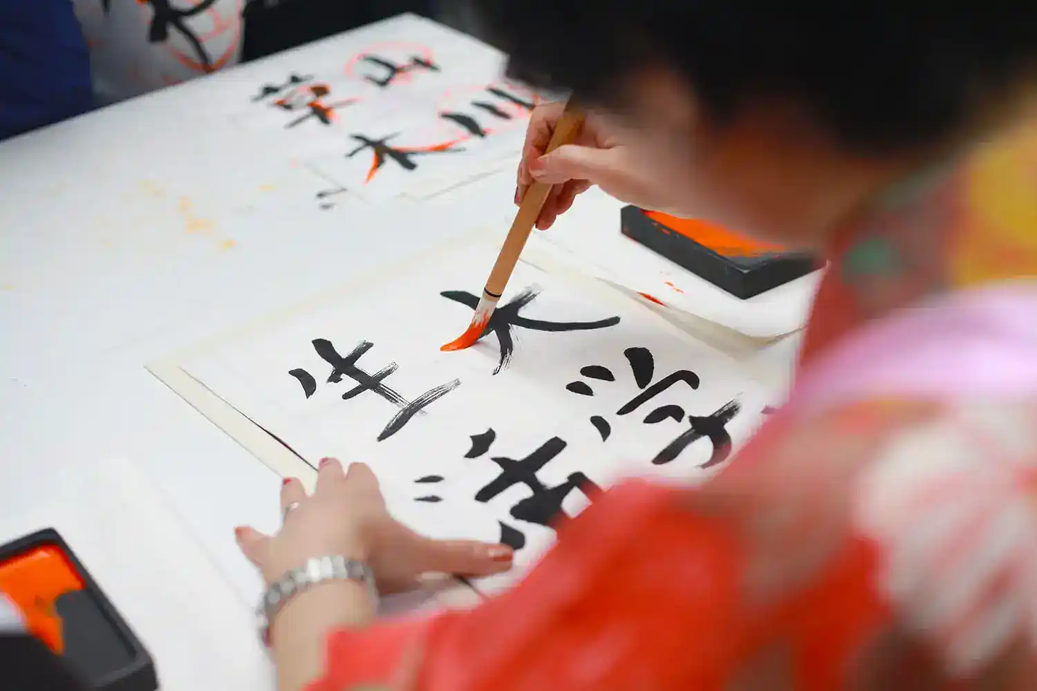Practising Japanese calligraphy with a brush